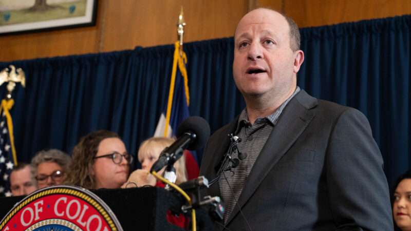 Colorado Governor Jared Polis speaks to reporters before signing a new gun control law. | Jesse Paul/Zuma Press/Newscom