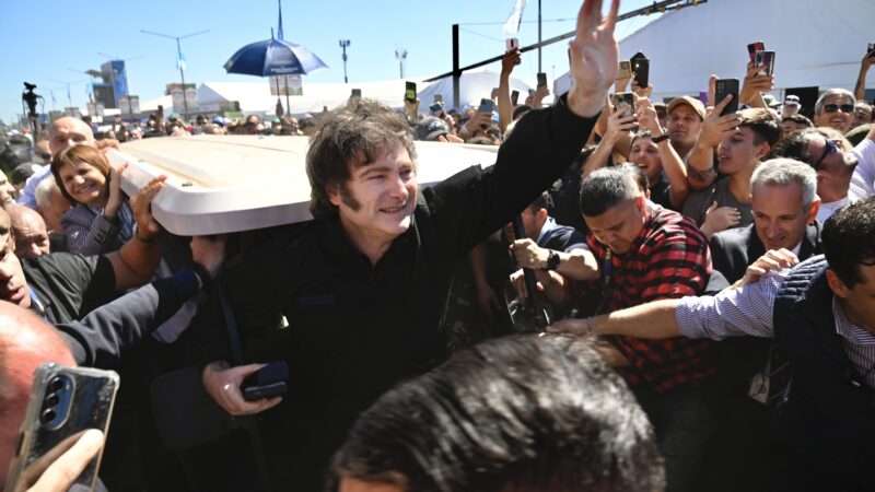 President Javier Milei stands outdoors and waves to a crowd surrounding him in Buenos Aires, Argentina | Marcelo Manera/Newscom