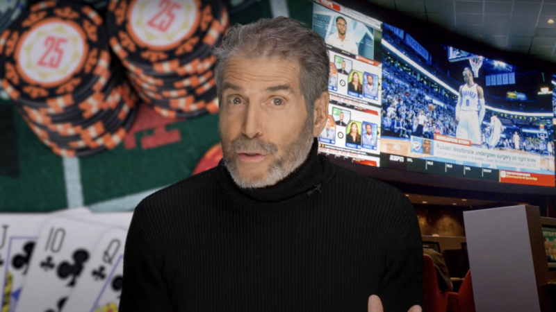 John Stossel is seen in front of gambling supplies | Stossel TV