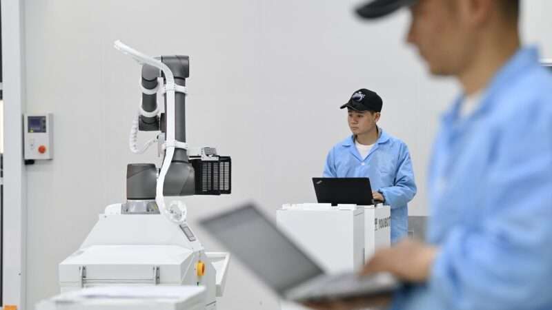 Technicians work at an industrial robot manufacturing factory in Hefei City in China. | Imagine China/Newscom