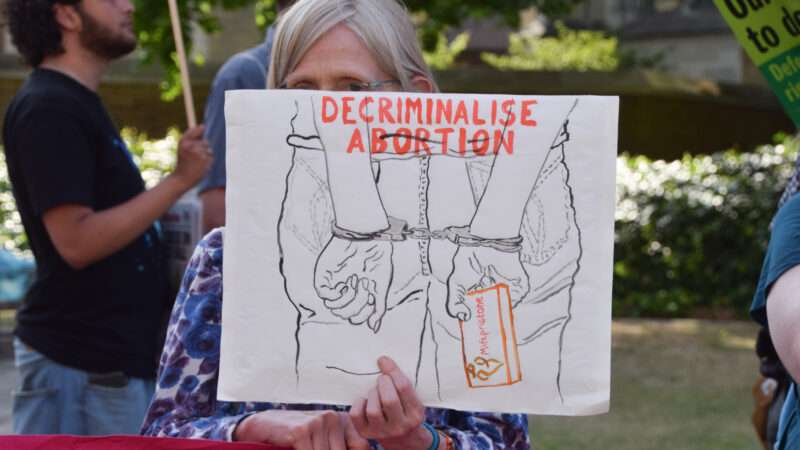 Protester holding up sign saying "decriminalize abortion" | Vuk Valcic/ZUMAPRESS/Newscom
