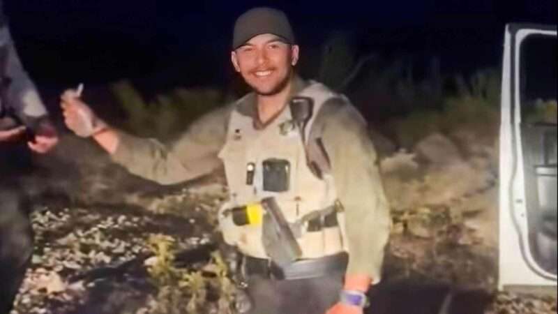 Grant County, New Mexico Sheriff's Deputy Alejandro Gomez holds a baby rabbit before hurling it against a police vehicle | Brandon Reese