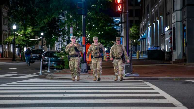 Three Tennessee National Guardsmen walk through a crosswalk in Washington, D.C. | Polaris/Newscom