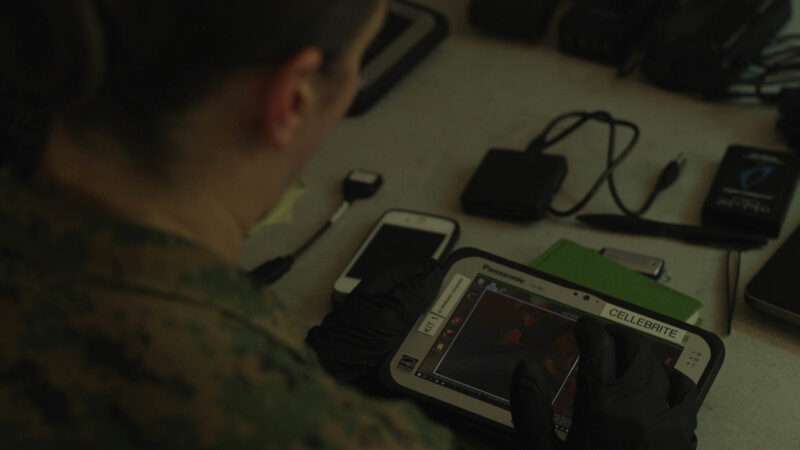 A criminal investigator with 2nd Law Enforcement Battalion (LE Bn), II Marine Expeditionary Force, Information Group extracts data from electronic devices with the Cellebrite tablet during an exercise in LZ Phoenix, N.C., May 20, 2019. | U.S. Marine Corps photo by Sgt. Luisa Torres
