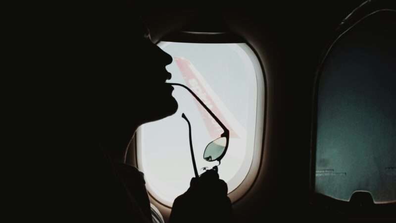 The outline of a person is seen with an airplane window in the background | Photo by <a href="https://unsplash.com/@lgnwvr?utm_source=unsplash&utm_medium=referral&utm_content=creditCopyText">LOGAN WEAVER | @LGNWVR</a> on <a href="https://unsplash.com/photos/person-in-car-looking-at-the-window-RiD-wabAD3E?utm_source=unsplash&utm_medium=referral&utm_content=creditCopyText">Unsplash</a>       