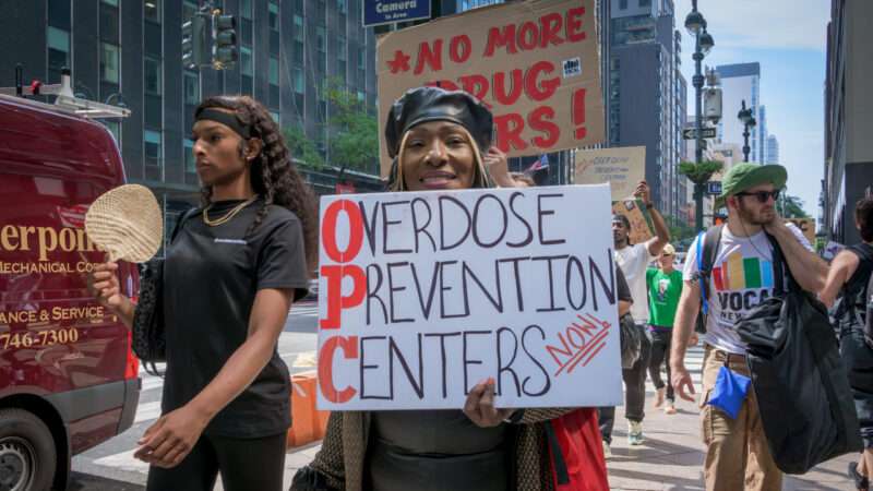 Protester holding sign saying 'Overdose Prevention Centers' | Erik McGregor/Sipa USA/Newscom
