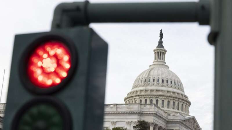 The U.S. Capitol building during the government shutdown, and in the foreground, a red traffic light | Aashish Kiphayet/Sipa USA/Newscom