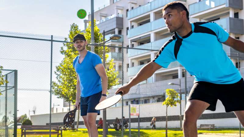 Two pickleball players outside on a sunny day. | ID 353614515 ©  Iván Las Heras | Dreamstime.com