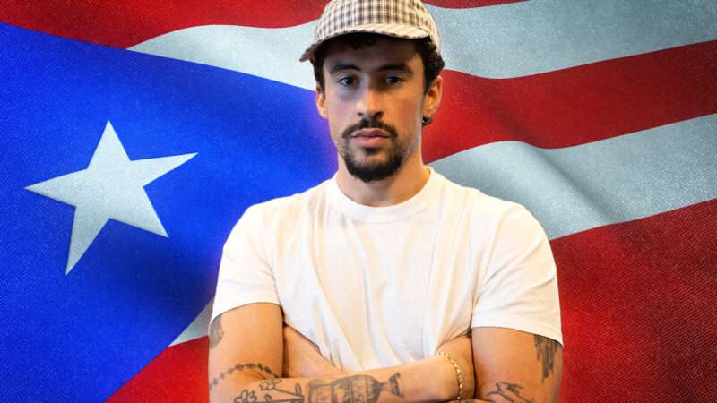 Bad Bunny with the Puerto Rican flag behind him | Credit: Xavier Araújo/Newscom/Envato