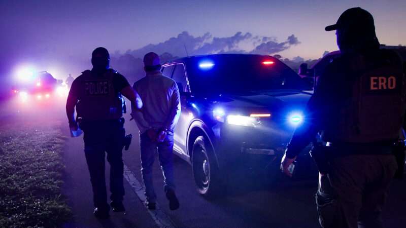 A photo of a law enforcement officer accompanying a detainee | U.S. Immigration and Customs Enforcement