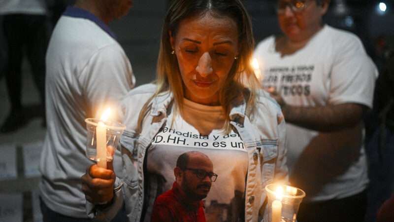 People holding candles at a vigil | Photo: Federico Parra/AFP/Getty