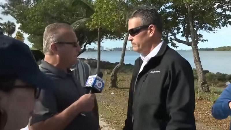 Local 10 News reporter Jeff Weinsier holds a microphone up to Miami-Dade Sheriff's Deputy Lester Aguilar. | WPLG Local 10 via YouTube
