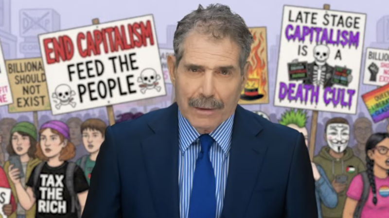 John Stossel stands in front of a cartoon depicting people protesting capitalism | Stossel TV