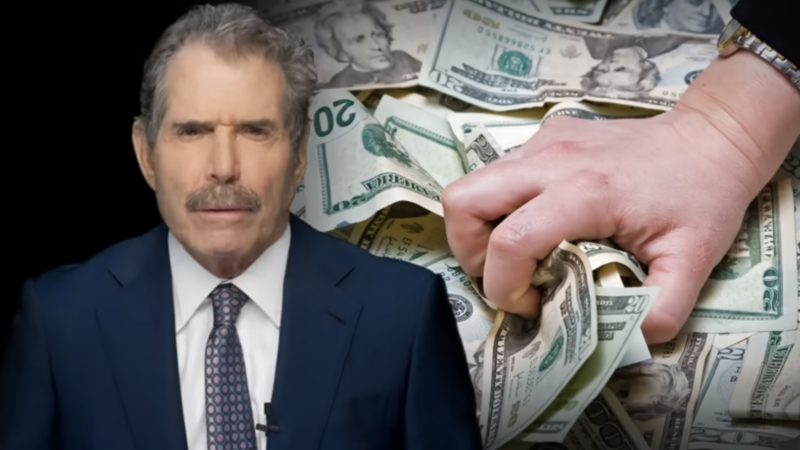 John Stossel stands next to a hand grabbing cash | Stossel TV