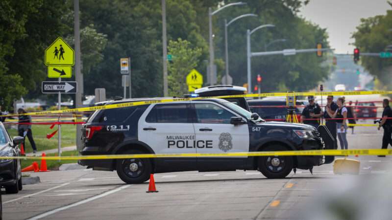 A Milwaukee Police Department vehicle on the road surrounded by crime scene tape | Pat A. Robinson/ZUMAPRESS/Newscom