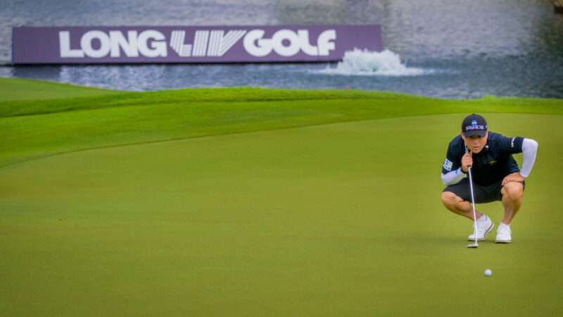 Golfer Richard T. Lee crouches over a fairly short putt, with a floating banner behind him that says 