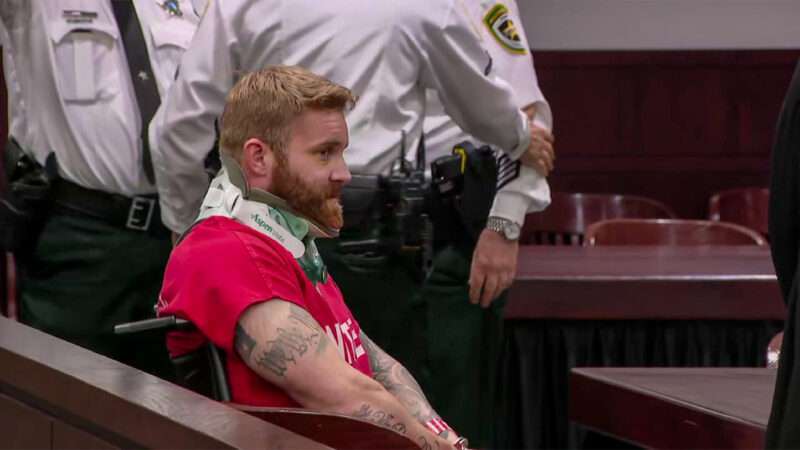 Zachary Krug in court, wearing a prison uniform and a neck brace | Hillsborough State Attorney's Office