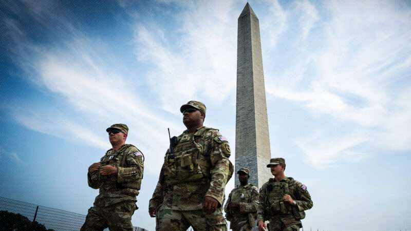 National Guard members in front of the Washington Monument | Photo: Graeme Sloan/Sipa USA/Newscom