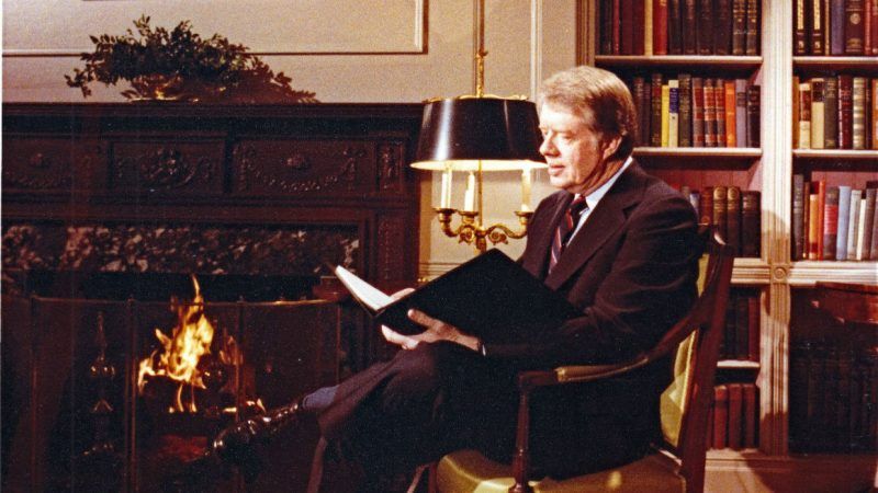 An old photo of Jimmy Carter sitting and reading | White House via CNP/MEGA/Newscom