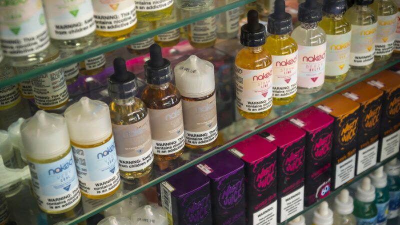 E-cigarette liquid bottles lined up on a shelf | Richard B. Levine/Newscom