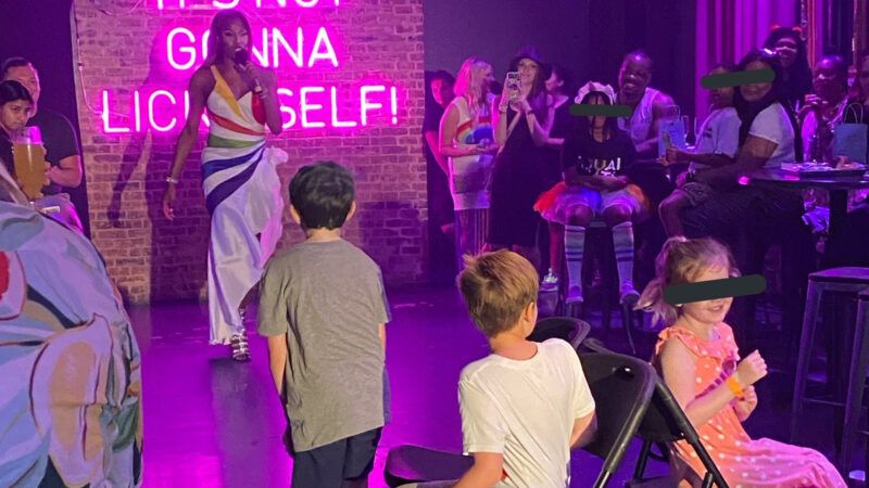 Children watching drag queen perform at a Texas gay bar.