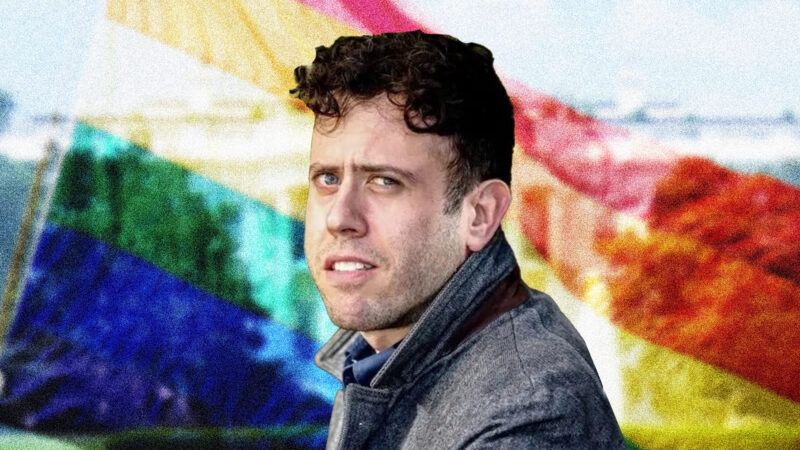 Author James Kirchik in front of a rainbow flag