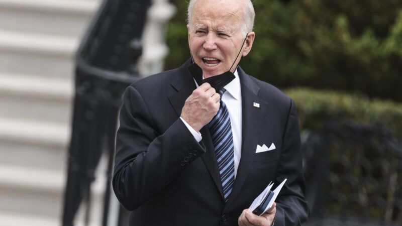 Joe Biden pulling a mask below his face | Oliver Contreras / Ron Sachs/CNP / SplashNews/Newscom