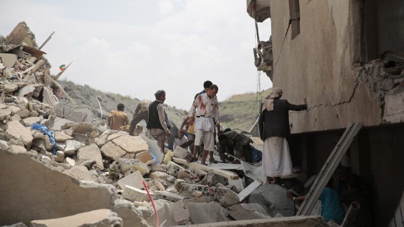 Yemenis inspect houses after an airstrike