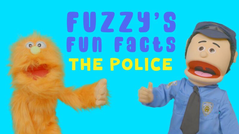 A puppet monster and puppet police officer pose for Fuzzy's Fun Facts about the police