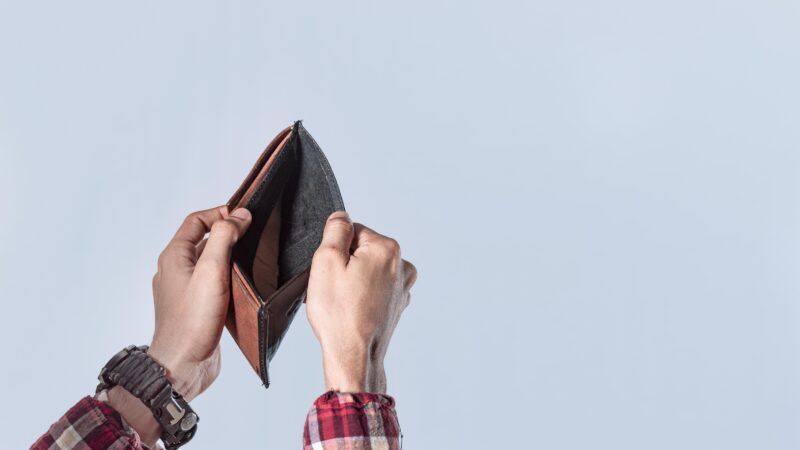 man holding empty wallet | imageBROKER/Isai Hernandez/Newscom