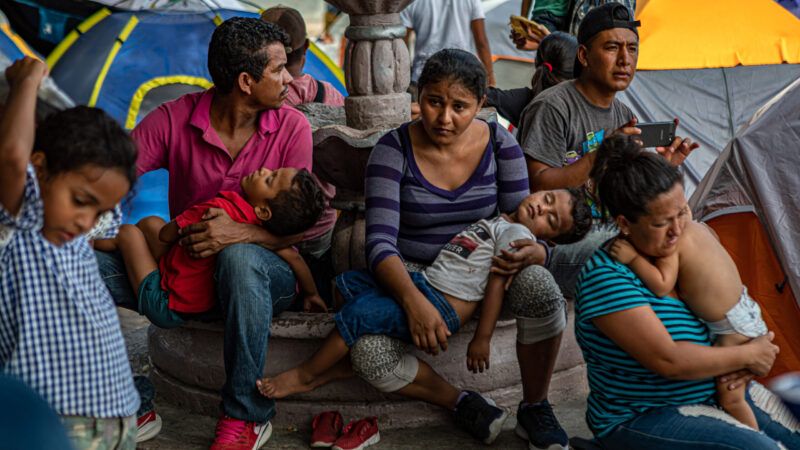A group of migrants wait in Mexico under President Donald Trump's "Remain in Mexico" program