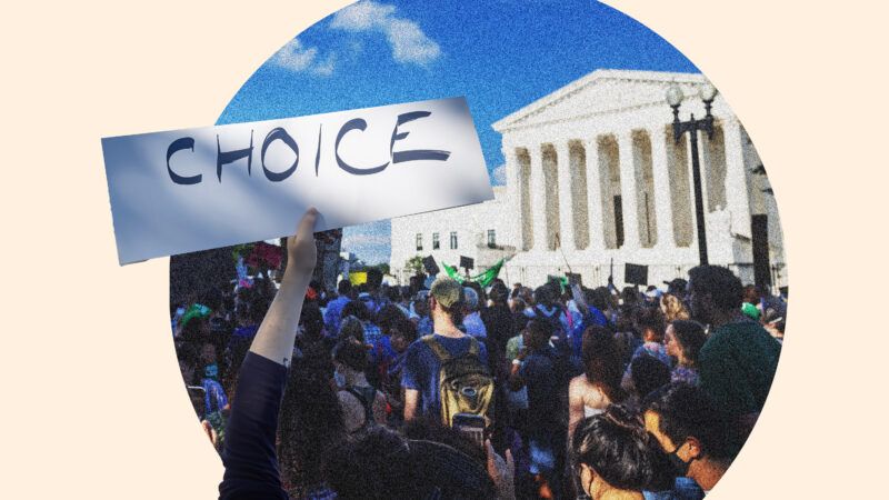 woman holds sign in front of supreme court