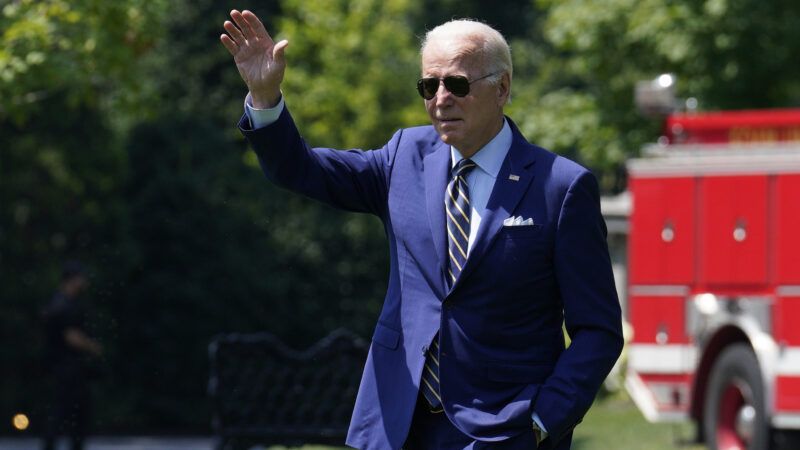 President Joe Biden waves while walking