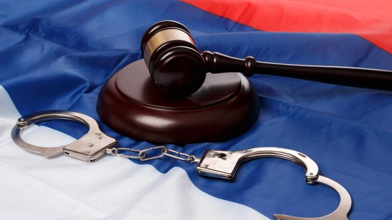 Russian flag with gavel and handcuffs
