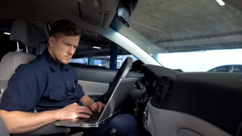 Cop in car operating laptop | Motortion / Dreamstime.com