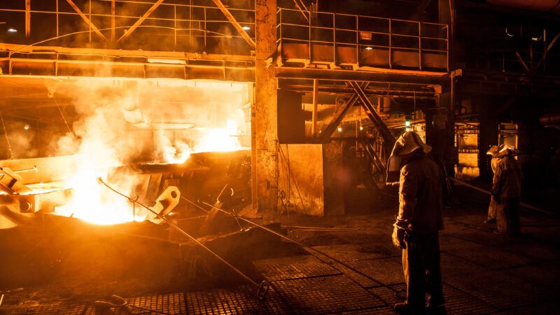 worker in a factory working with hot metal in protective gear | DPST/Newscom