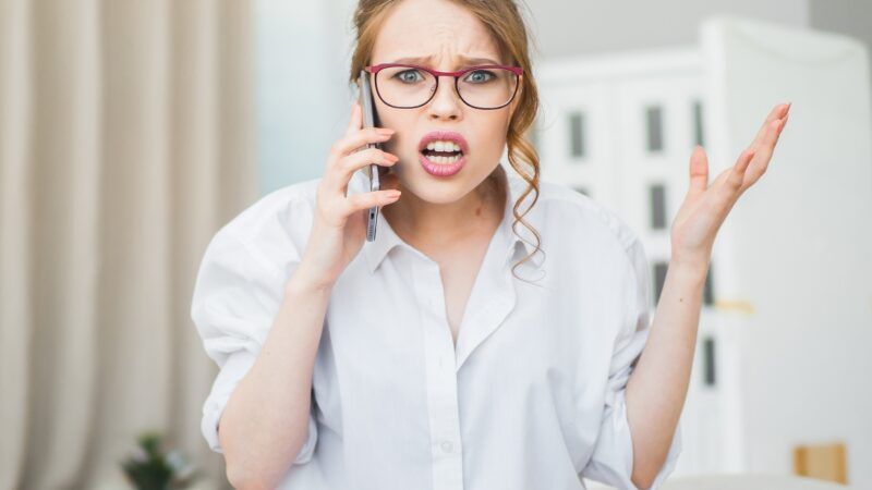Frustrated woman making phone call