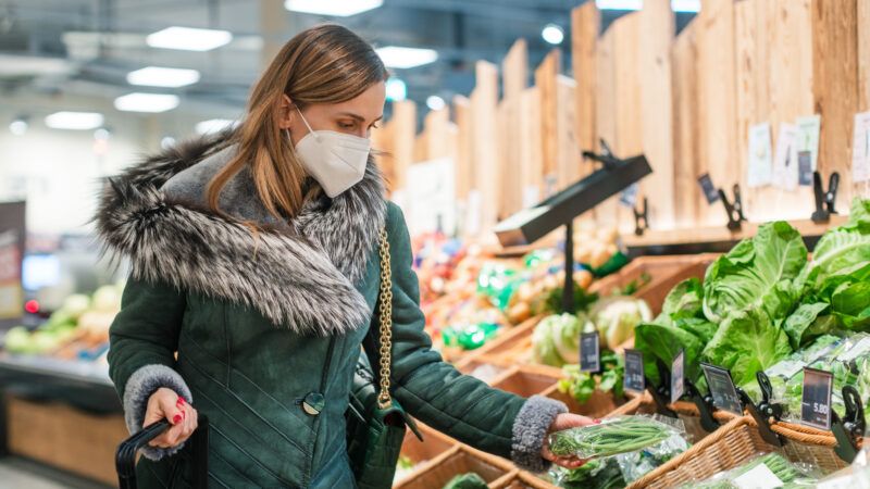 a woman wearing a mask in a grocery store