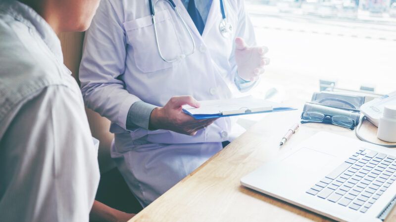 doctors confer over a document