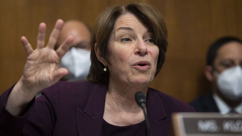 Amy Klobuchar with her hand up