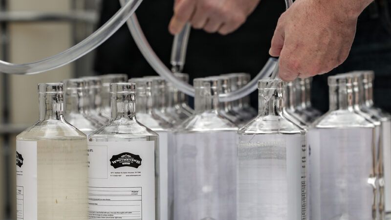 Bottles of hand sanitizer are lined up to get filled on a table | Photo 177552355 © Edwin Correa | Dreamstime.com