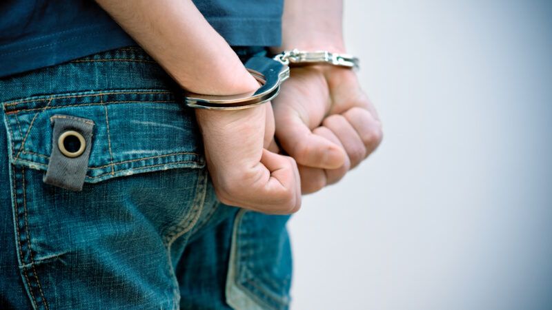Teenage boy in handcuffs