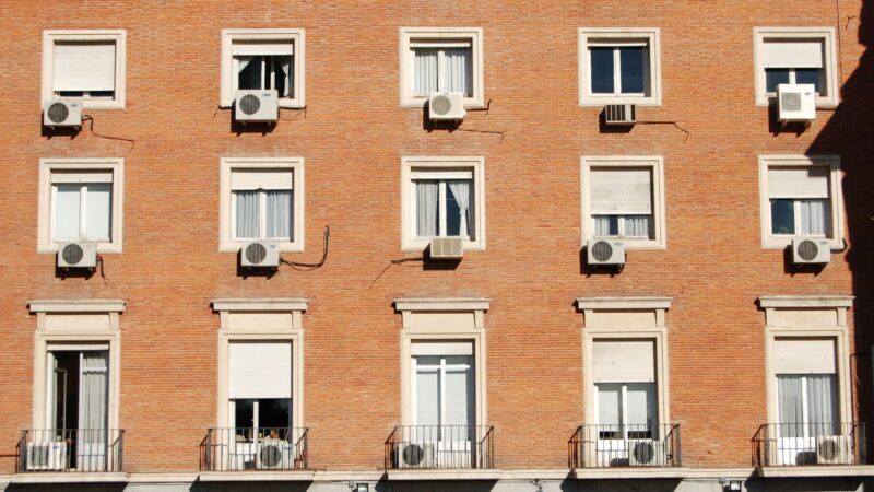 Windows in an apartment building filled with air conditioning units | Photo 7218869 © Philip Haskins | Dreamstime.com