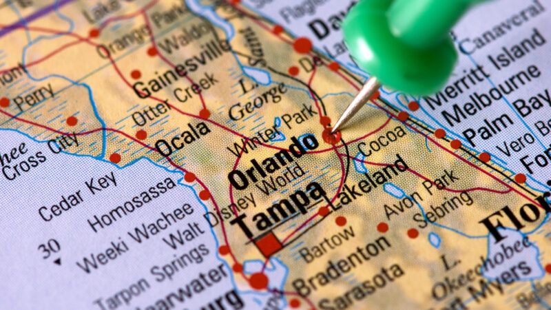 close-up of Florida on map with a green pin stuck by Orlando