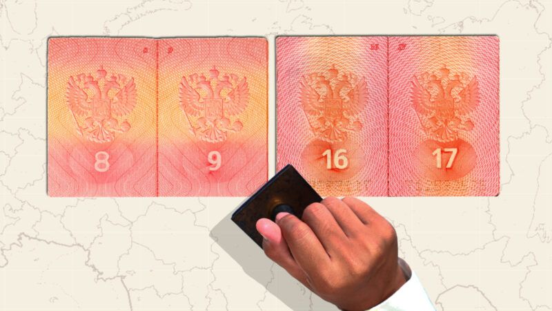A hand holds a stamp over two Russian passports and a map of Russia