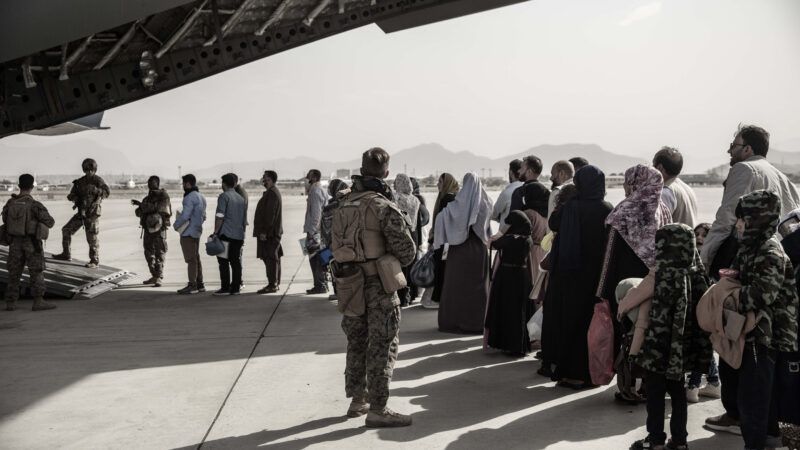 Afghan evacuees wait to board a U.S. aircraft in Kabul, Afghanistan