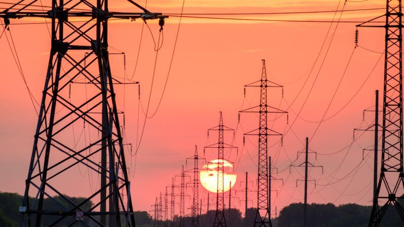 Power lines silhouetted against the sunset power grid green energy Manchin permitting reforms Congress progressives Bernie Sanders Elizabeth Warren