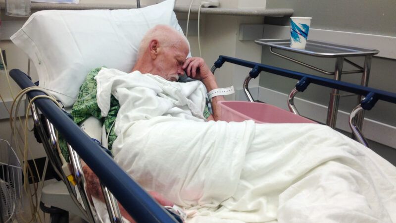 Elderly man in hospital bed.