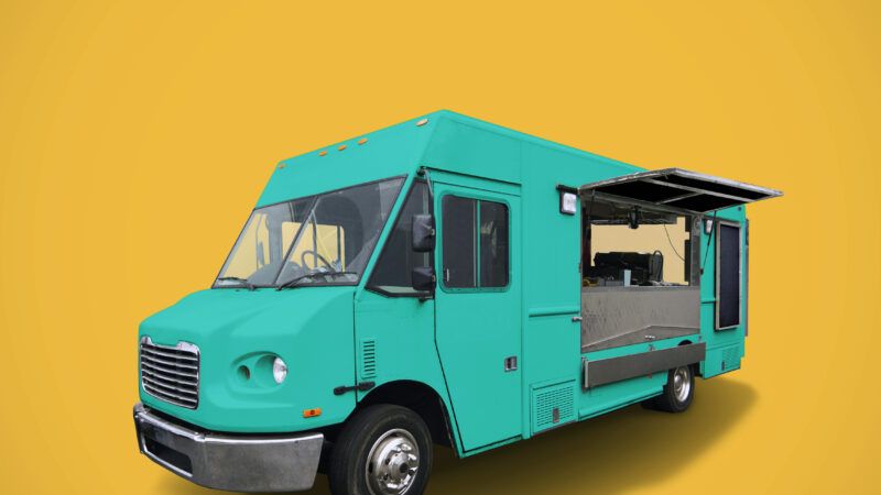 Classic green food truck on yellow background
