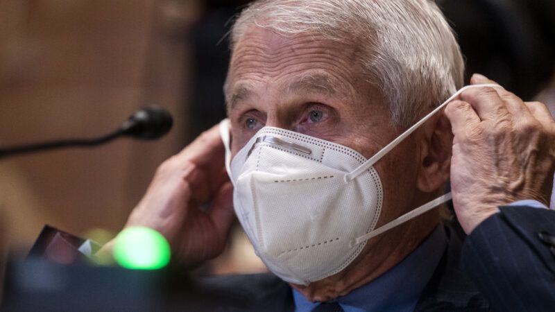 Anthony Fauci puts on a mask.